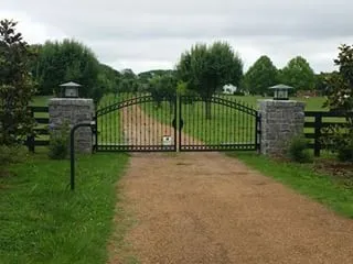 A gate that is open on the side of a road.