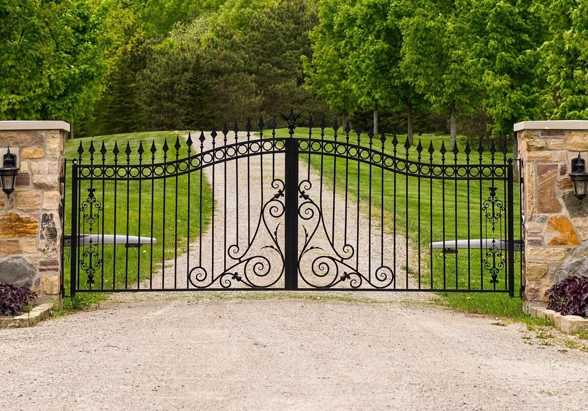 A gate that is open on the side of a road.
